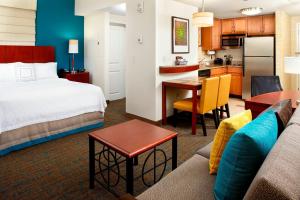 a hotel room with a bed and a kitchen at Residence Inn Columbus Downtown in Columbus