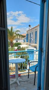 a table and a chair on a balcony with a view at Pension Panagiota in Spetses