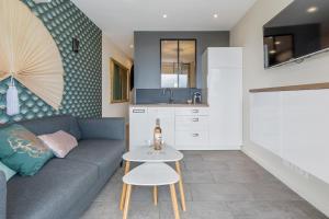 a living room with a couch and a table at Zen et Summer Zen coursive naturiste in Cap d'Agde