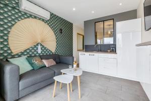 a living room with a couch and a table at Zen et Summer Zen coursive naturiste in Cap d'Agde