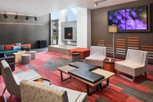 a living room with furniture and a fireplace at Aloft Seattle Sea-Tac Airport in SeaTac