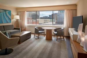 a living room with a couch and a table and a window at Sheraton Ottawa Hotel in Ottawa