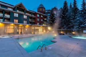 a hotel with a swimming pool at night at Delta Hotels by Marriott Whistler Village Suites in Whistler