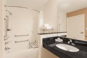 a white bathroom with a sink and a shower at Fairfield Inn & Suites Victoria in Victoria