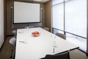 einen Konferenzraum mit einem weißen Tisch und einer Obstschale in der Unterkunft SpringHill Suites by Marriott Savannah I-95 South in Savannah