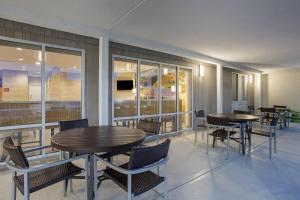 un comedor con mesas, sillas y ventanas en TownePlace Suites by Marriott Knoxville Oak Ridge, en Oak Ridge