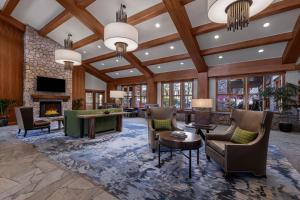 a living room with a stone fireplace and furniture at Marriott Grand Residence Club, Lake Tahoe in South Lake Tahoe