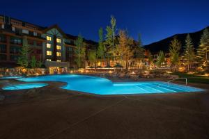 a large swimming pool in front of a hotel at night at Marriott Grand Residence Club, Lake Tahoe in South Lake Tahoe