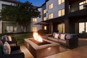a fire pit in front of a building with couches at Courtyard by Marriott Tulsa Central in Tulsa