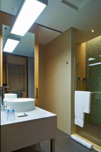 a bathroom with a sink and a shower at Aloft Dongguan Songshan Lake in Dongguan