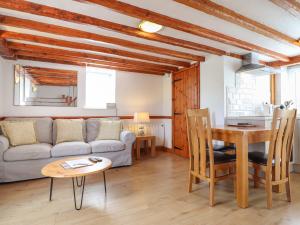 a living room with a couch and a table at Oak Cottage in Conwy