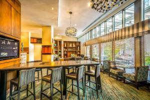 a large kitchen with a large bar with chairs at Residence Inn Arlington Courthouse in Arlington