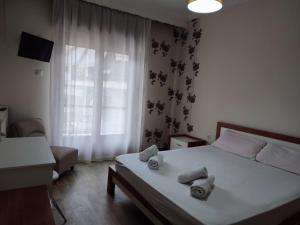 a bedroom with a bed with towels on it at Olena House in Kavala