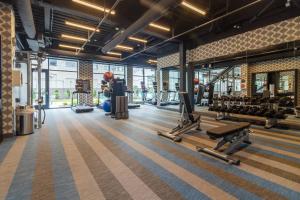 a gym with treadmills and machines in a building at Aloft St. Louis Cortex in Saint Louis