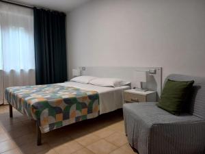 A bed or beds in a room at Hotel Cormorano