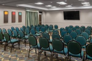 a conference room with chairs and a screen at Residence Inn by Marriott Covington Northshore in Covington