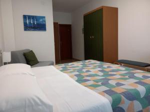 A bed or beds in a room at Hotel Cormorano