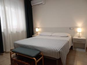 A bed or beds in a room at Hotel Cormorano