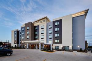 a hotel with a car parked in a parking lot at TownePlace Suites by Marriott St. Louis O'Fallon in O'Fallon