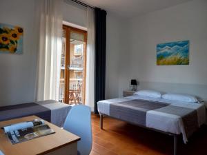 A bed or beds in a room at Hotel Cormorano