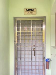 une porte avec un panneau qui ne dit pas de maison secrète dans l'établissement Mr Singh Homestay, à Kampong Tanah Merah