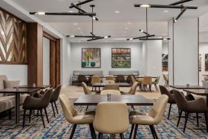 a waiting room with tables and chairs at Delta Hotels by Marriott Bristol in Bristol