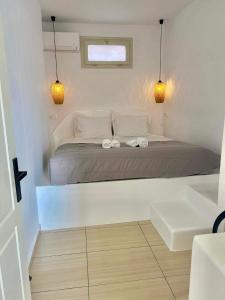 a bedroom with a bed with two towels on it at BlackRock suites in Karterados