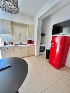 a kitchen with a red refrigerator and a table at BlackRock suites in Karterados
