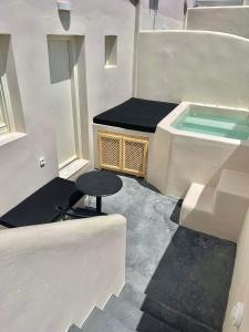 um quarto com uma piscina e um banco num edifício em BlackRock suites em Karterados