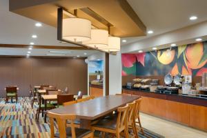 a dining room with a table and chairs at Fairfield Inn & Suites Salt Lake City Airport in Salt Lake City