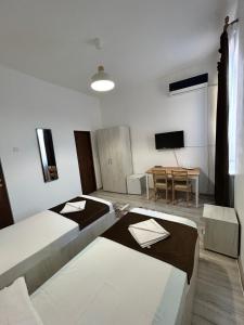 a living room with two beds and a table at Hotel Continental City Center in Iaşi +29 photos