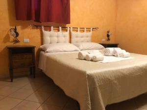 a bedroom with a bed with towels on it at L’attico Piazza Sant’Oronzo in Lecce