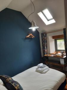 a bedroom with a blue accent wall and a bed at Longstone Luxury Country Boutique Two Bedroom Cottage, Exmoor, Challacombe, North Devon in Challacombe