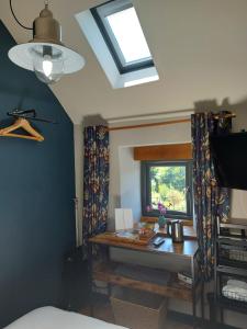 a bedroom with a desk and a window at Longstone Luxury Country Boutique Two Bedroom Cottage, Exmoor, Challacombe, North Devon in Challacombe