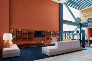 a living room with a couch and a tv at Courtyard by Marriott Mexico City Toreo in Mexico City