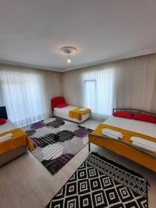 a room with two beds and a rug at My Home in Beysehir