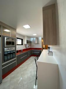 a kitchen with a white counter and a white refrigerator at Local 401 Apartment in Rio de Janeiro