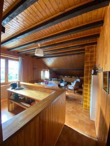 a large kitchen with wooden walls and wooden floors at Appartement chalets T2 50m2 in Publier