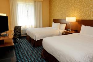 a hotel room with two beds and a flat screen tv at Fairfield by Marriott Inn & Suites Jonestown Lebanon Valley in Jonestown