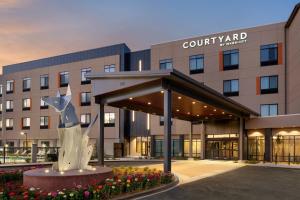 a building with a statue in front of a building at Courtyard by Marriott Petaluma Sonoma County in Petaluma