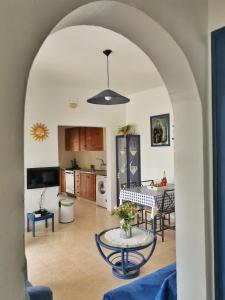 a kitchen and a living room with a table at Caseta de pescadors a les cales de Colera, 2ª linea de mar in Colera