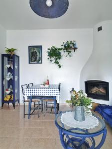 a living room with a table and a dining room at Caseta de pescadors a les cales de Colera, 2ª linea de mar in Colera