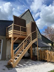 a large wooden staircase leading up to a house at Gite au gré de la Loire piscine et spa in Saint-Mathurin +10 photos