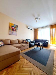 a living room with a couch and a table at Lidda Apartment in residential area in Varna City