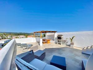 a patio with chairs and a grill on a roof at Villaggio Camping Oasi in Vieste