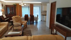 a living room with a couch and a dining room at Zichy Ház in Keszthely