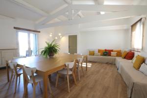a living room with a wooden table and a couch at Bastide Magnolia - Les dépendances, Roussillon in Roussillon