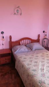 a bedroom with a bed and a table with a lamp at Maison familliale Saint Pierre in Sainte-Luce