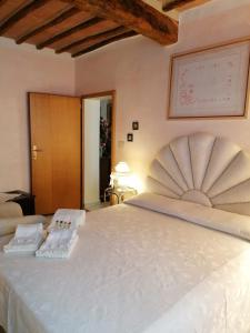 a bedroom with a large white bed with two pillows at La Bomboniera di Siena in Siena