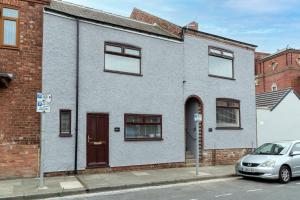 a house with a car parked in front of it at Amazing House with Central Location in Darlington